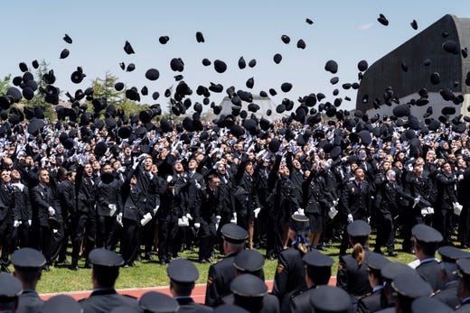 epa07645548 Some 2.500 policemen throw their caps to the air as they attend their graduation ceremony at the National Police Academy in Avila, Spain, 13 June 2019. EPA-EFE/RAUL SANCHIDRIAN ORG XMIT: GRAF7754