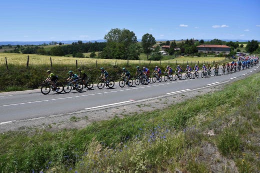 TOPSHOT - The pack rides during the fifth stage of the 71st edition of the Criterium du Dauphine cycling race, 201 km between Boen-sur-Lignon and Voiron on June 13, 2019. (Photo by Anne-Christine POUJOULAT / AFP)ANNE-CHRISTINE POUJOULAT/AFP/Getty Images ORIG FILE ID: AFP_1HH2B1