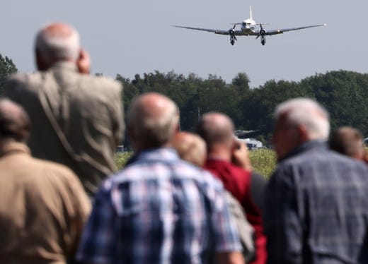 epa07645513 Plane spotters watch a landing DC-3 heritage plane during a spotter day at the German Air Force's airfield in Jagel, northern Germany, 13 June 2019. On the occasion of the 70th anniversary of the Berlin Airlift, about a dozen of former 'Raisin Bombers' (Rosinenbomber) planes met in Jagel. From 1948 to 1949, during the Berlin blockade, planes of the Western Allied Forces carried food and fuel from Western Germany to Berlin. EPA-EFE/FOCKE STRANGMANN