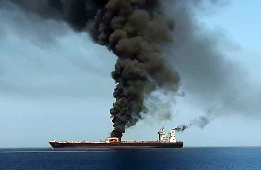 Smoke billows from a tanker off the coast of Oman on June 13.