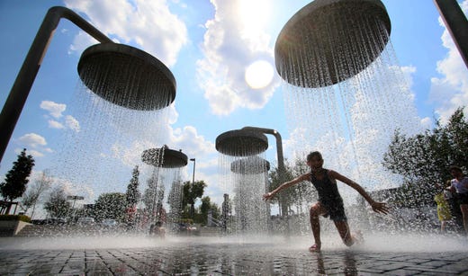 Children play under showers that are part of a public fountain to cool off on June 13, 2019 in Vilnius, where temperatures rose up to 35 degrees Celsius. (Photo by Petras Malukas / AFP)PETRAS MALUKAS/AFP/Getty Images ORIG FILE ID: AFP_1HH2HA