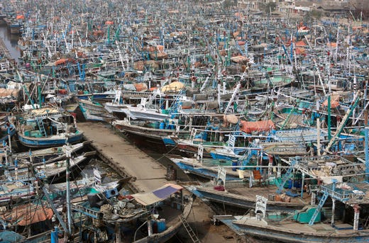Pakistani fishing boats are called back from the sea following a warning by authorities of Cyclone Vayu at Karachi harbor in Pakistan, Thursday, June 13, 2019. The meteorological department Thursday issued an alert, warning fishermen to avoid fishing in the Arabian sea this week as the Cyclone Vayu could cause rough conditions in the sea. (AP Photo/Fareed Khan) ORG XMIT: ISL103
