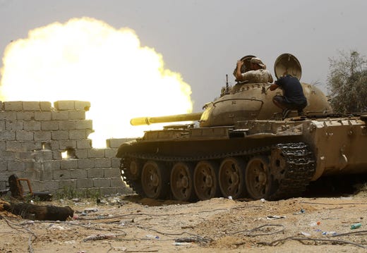 Fighters loyal to the internationally-recognised Government of National Accord (GNA) open tank fire from their position in the al-Sawani area south of the Libyan capital Tripoli during clashes against forces loyal to strongman Khalifa Haftar, on June 13, 2019. (Photo by Mahmud TURKIA / AFP)MAHMUD TURKIA/AFP/Getty Images ORIG FILE ID: AFP_1HH4S3