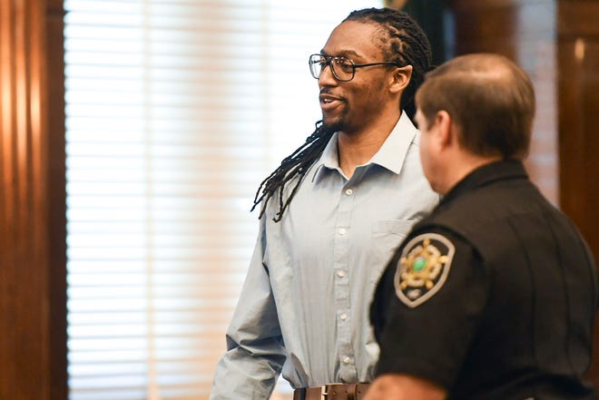 Nathaniel Dixon talks to someone watching the trial as the courtroom is dismissed for a break June 14, 2019.