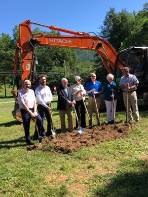 From left to right: Montreat officials commissioner Tom Widmer, town administrator Alex Carmichael, mayor Tim Helms, commissioners Alice Lentz, Bill Gilliland, Kitty Fouche and Kent Otto break ground on a new town hall on June 11.