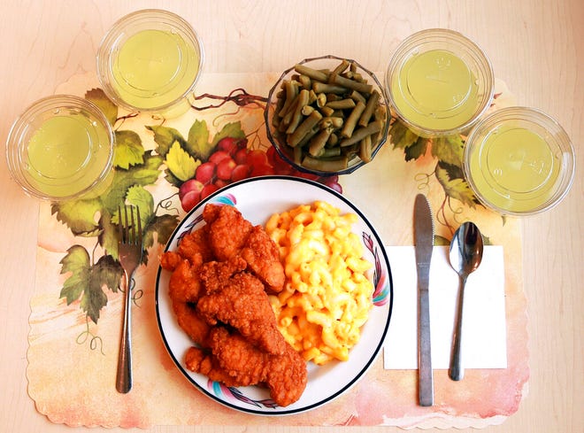 This undated photo provided by the National Institutes of Health in June 2019 shows an "ultra-processed" lunch including brand name macaroni and cheese, chicken tenders, canned green beans and diet lemonade. Researchers found people ate an average of 500 extra calories a day when fed mostly processed foods, compared with when the same people were fed minimally processed foods. Thatâ€™s even though researchers tried to match the meals for nutrients like fat, fiber and sugar.