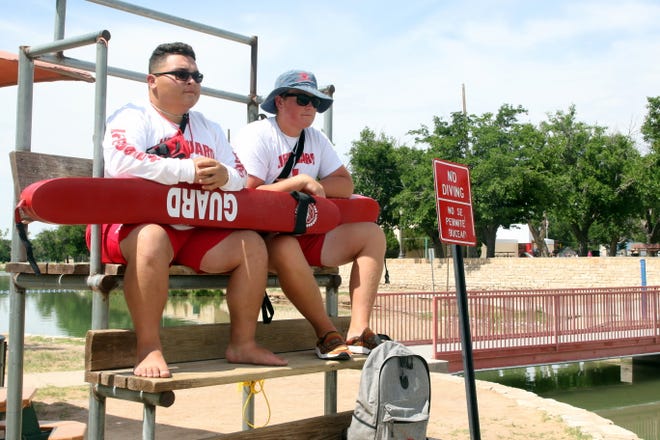 Andrew Easley, left, and Mason McGeath, right, stand guard at the Pecos River on Friday. Lifeguards working the Pecos River save about 50 people a year from various water accidents and incidents.