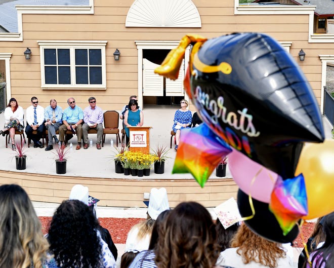 "Congrats Grad!" balloons float in front of the stage as Carla Loomis addresses the 2019 Rancho Cielo Drummond Culinary Academy graduates. June 13, 2019.