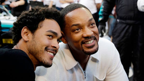 Will Smith, right, and his son Trey visit the pit...