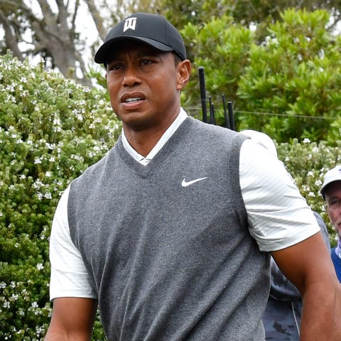 Tiger Woods strides to the fifth green after...