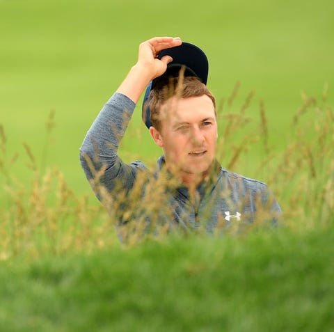Jordan Spieth reacts after his shot from a bunker...