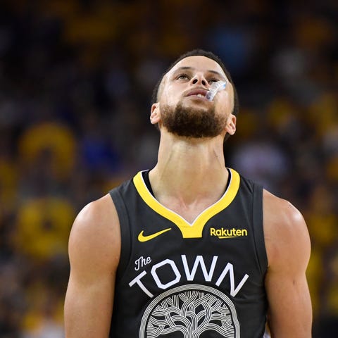 Golden State Warriors guard Stephen Curry reacts...