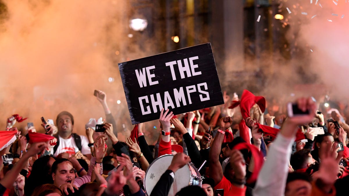Raptors fans celebrate as they watch the broadcast of Game 6 at a viewing party outside Scotiabank Arena.