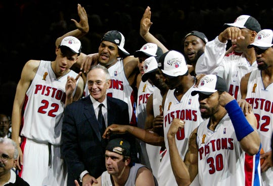Detroit Pistons coach Larry Brown and his players celebrate their win in Game 5 of the NBA Finals.