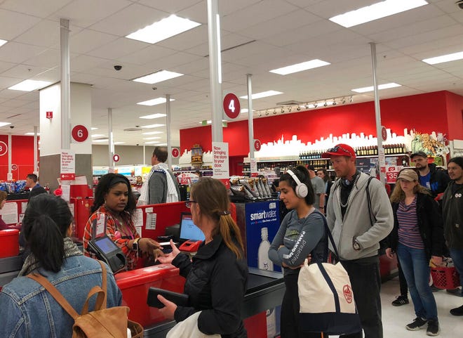 Customers wait on a long check out line at a Target store in San Francisco on Saturday, June 15, 2019.  Target suffered a technological glitch that stalled checkout lines at its stores worldwide Saturday, exasperating shoppers and eating into sales at a prime time for retailers. The outage periodically prevented Target's cashiers from scanning merchandise or processing transactions. Self-checkout registers also weren't working at times, causing massive lines in some stores.