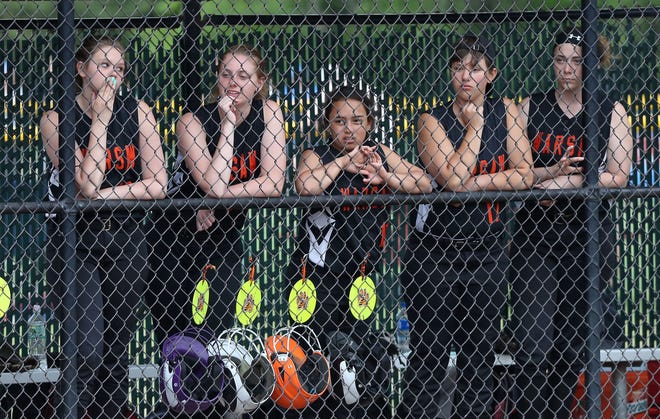 Warsaw players watch as Edison scores a run during the Class C state softball championship game at Moreau Recreational Park in Glens Falls, New York on June 15,  2019.