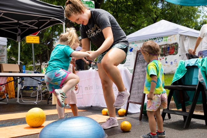 In this file photo, Kendra Witt teaches a child how to use the exercise equipment at Open Streets in Fort Collins.