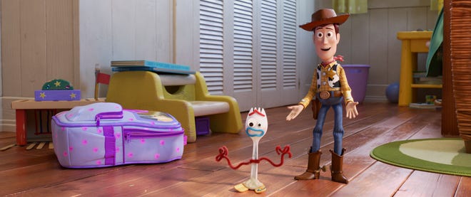 Woody (right, voiced by Tom Hanks) welcomes Forky (Tony Hale) to the gang in "Toy Story 4."