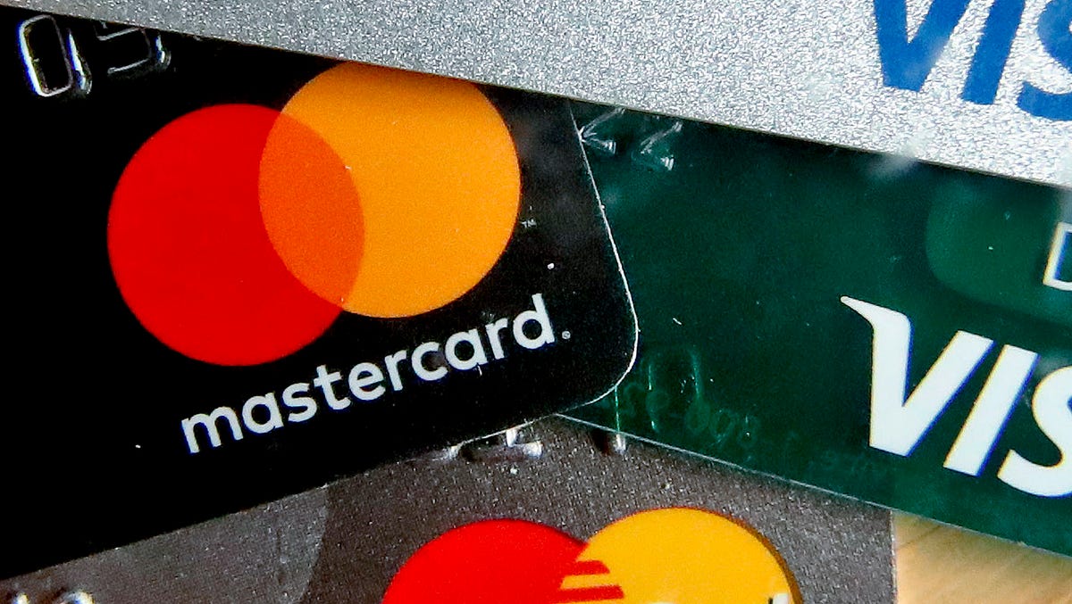 FILE - In this Feb. 20, 2019, file photo photo shows a logo for Mastercard on credit cards in Zelienople, Pa. Mastercard will allow transgender people to use their chosen names on credit cards in an effort to combat potential discrimination at the cash register. That means that the name on the credit card owned by a transgender person could be different than that found on their birth certificate or driverâ€™s license. (AP Photo/Keith Srakocic, File)