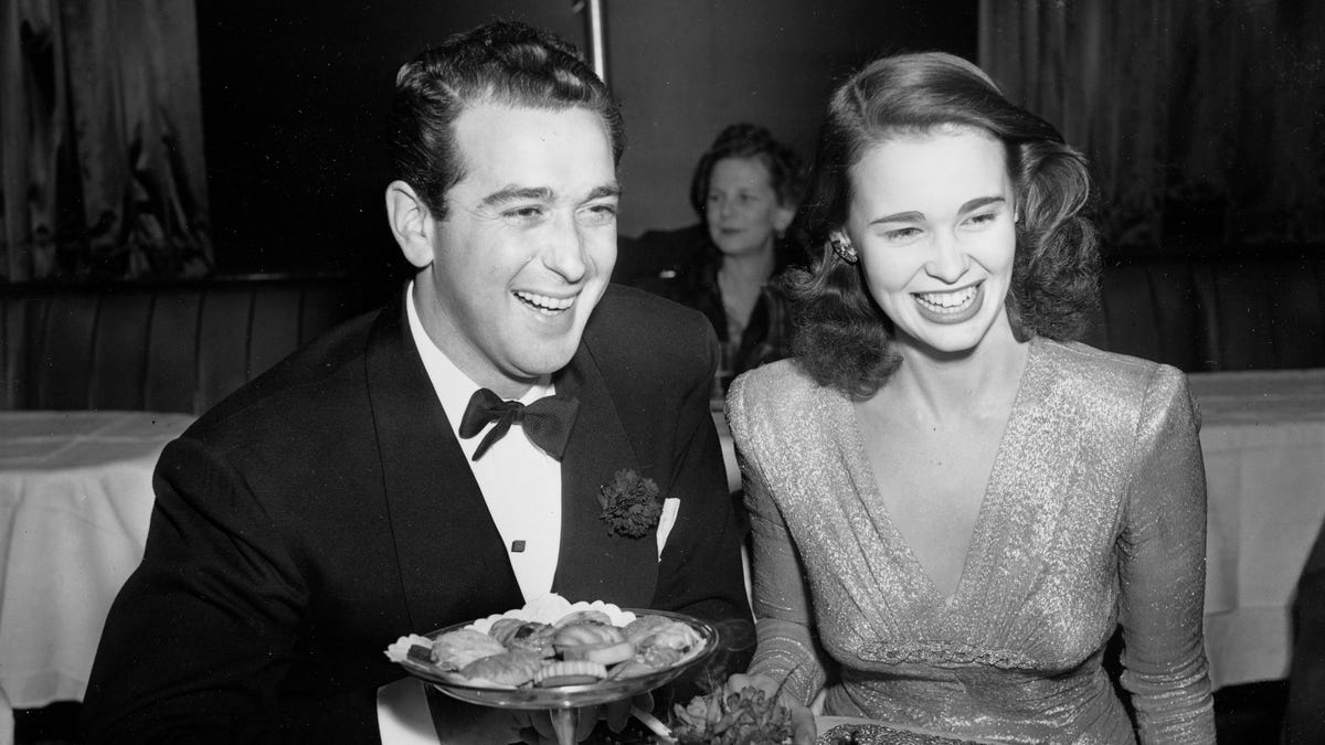 Gloria Vanderbilt, 17-year-old heiress to the $ 4,000 000 fortune of her late father, Reginald Vanderbilt, celebrates her engagement to Pasquale "Pat" Di Cicco, a Hollywood actor's agent, at New York's Stork Club, December 12, 1941. Gloria's mother, Mrs. Gloria Morgan Vanderbilt, announced that the couple will marry on Christmas Day in California.  (AP Photo)