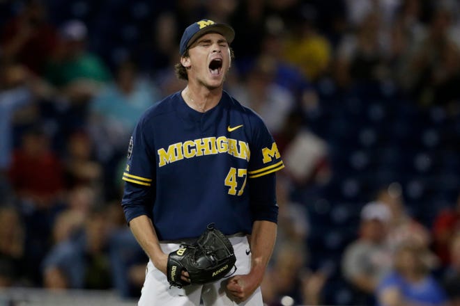 Michigan pitcher Tommy Henry (47) reacts after finishing off his complete-game gem against Florida State in the College World Series.