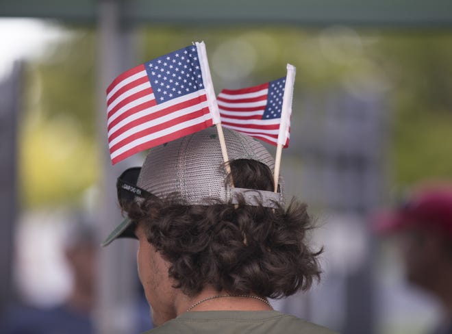 A man wears American flags in his hat during the Uncle Sam Jam to celebrate Independance Day at Parc International in Lafayette Monday, July 3, 2017.