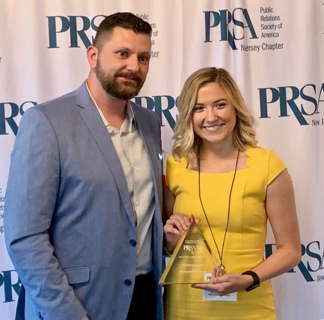 Monmouth University senior Karalyn Hoover, right, who lives in East Brunswick, won the Future Public Relations Pro of the Year Award during the Public Relations Society of America New Jersey’s 30th Annual Pyramid Awards at the Basking Ridge Country Club. Representing the award sponsor, Johnson & Johnson, Michael Lauer, left, presented the award.