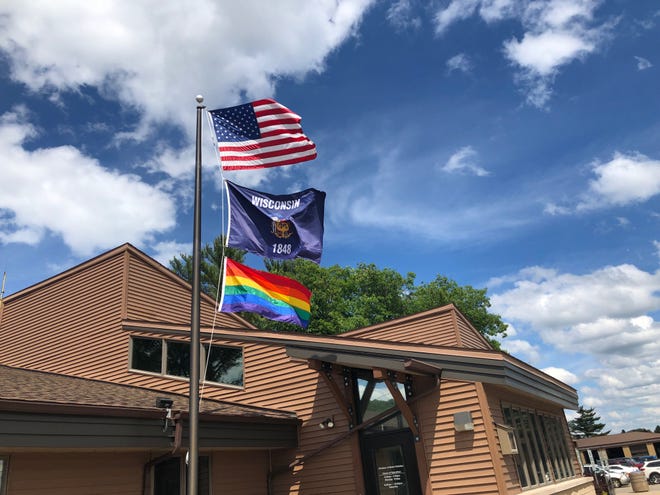 A Pride flag flies below the Wisconsin and American flags at the Rib Mountain Department of Motor Vehicles in Marathon County on June 18.