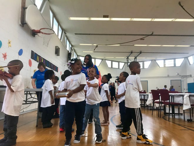 Children from Karla Bennett's pre-K class learn how to play the violin and other percussion instruments Thursday during a "Sesame Street" 50th anniversary event at Fleming Early Learning Neighborhood Center in Detroit.