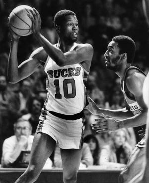 Bob Dandridge of the Bucks works against Don Collins in a game during the 1981 season.