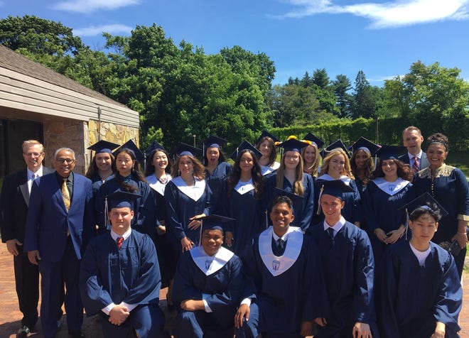 Faith Christian Academy's graduating class poses together.