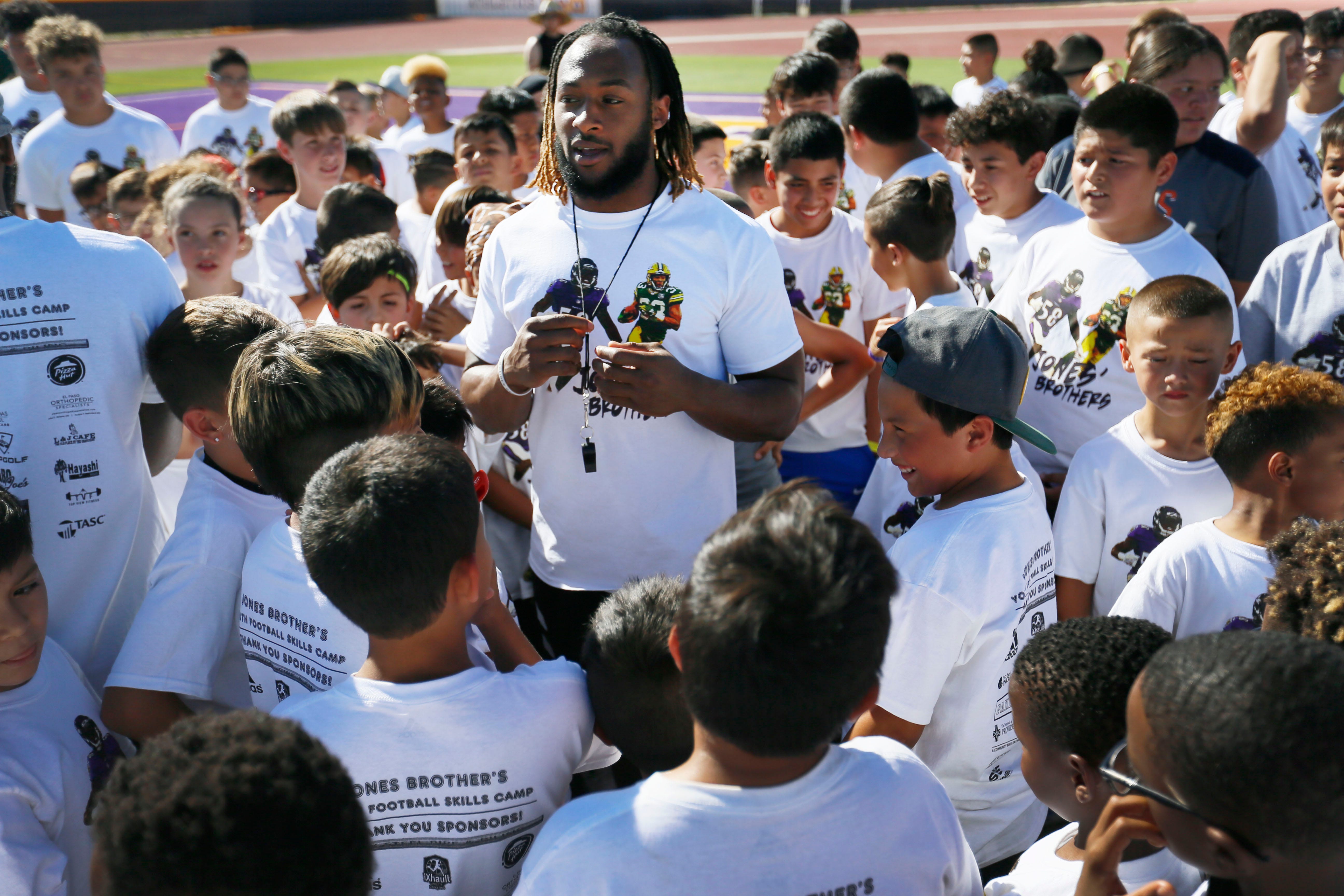 Running back for the Green Bay Packers Aaron Jones talks to the kids before they start running drills at the Jones Brothers Youth Football Skills Camp Wednesday, June 19, 2019 at Burges High School in El Paso. Aaron and Alvin Jones have hosted the camp since 2017. The brothers played football at Burges High School and were standouts at UTEP.