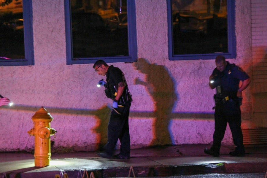 Police look for evidence early Thursday, June 20, 2019, in Allentown, Pa., following a shooting outside a nightclub.  The street shooting in eastern Pennsylvania that left 10 people wounded early Thursday is likely to be gang-related, authorities said.