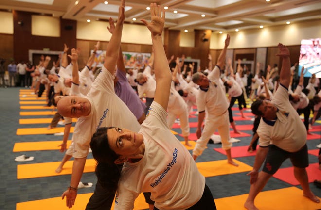 Diplomats of various countries perform yoga to mark International Yoga Day in New Delhi, India.