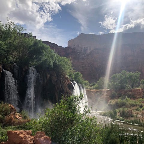 A beam of sun penetrates the clouds at Navajo Fall