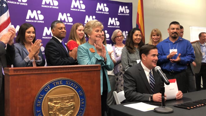 Gov. Doug Ducey signs Senate Bill 1040, which establishes a committee dedicated to understanding and preventing maternal deaths, on Friday, June 21, 2019.