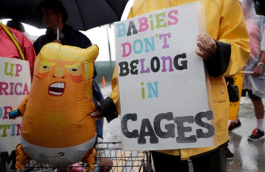 Protesters hold an inflatable doll with President Donald Trump in front of the Homestead Unaccompanied Children's Shelter on Sunday, June 16, 2019 in Homestead, Florida. A coalition of religious groups and immigration advocates said they wanted the closure of the Homestead Detention Center. (AP Photo / Lynne Sladky)