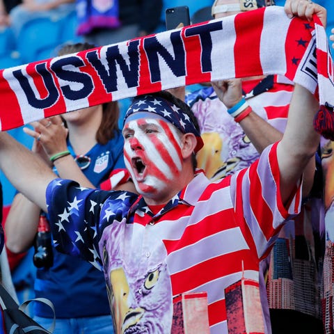 U.S. fans cheer before group stage play against...