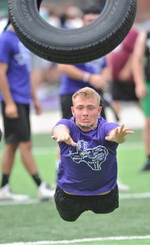 Anson's Kyle St. John throws a tire during the State LineMAN Challenge on Saturday, June 22, 2019, at Hardin-Simmons' Shelton Stadium. Five linemen from each team threw the tire, one after the other, to see how far down the field they could throw it overall. It was one of 11 events in the Challenge.