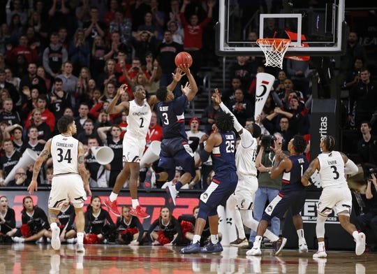 Connecticut Huskies guard Alterique Gilbert (3) puts up the shot to tie the game and send it t overtime against Cincinnati Bearcats guard Keith Williams (2) during the second half of a basketball game Saturday, Jan. 12, 2019 in Cincinnati. Cincinnati won 74-72 in overtime.