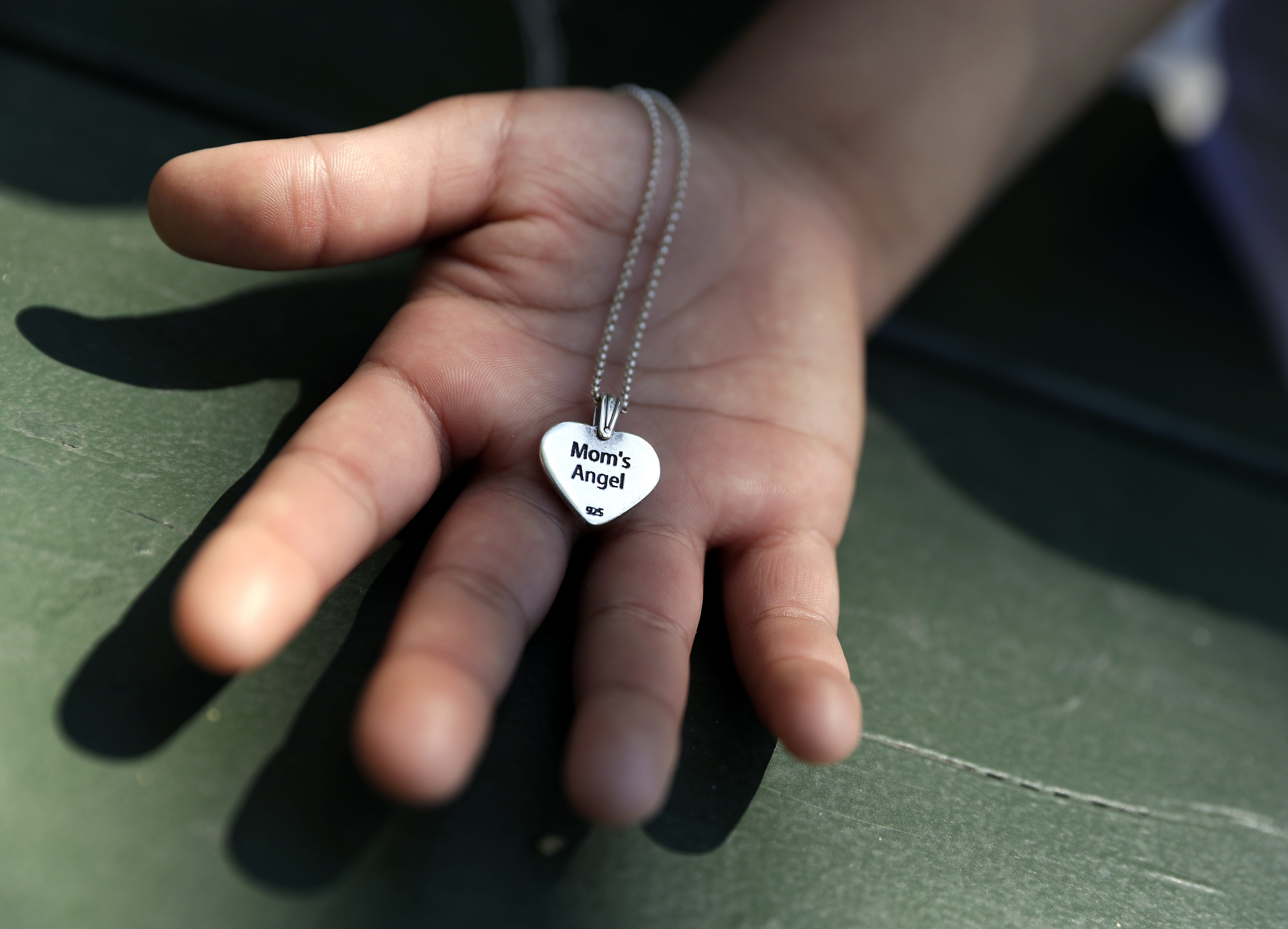 Concepcion Melgar wears a heart-shaped necklace that says "Mom's Angel" on one side. The other side has the fingerprint of her son Federico Abarca Jr., who was killed in February 2019. Sarah Kloepping/USA TODAY NETWORK-Wisconsin