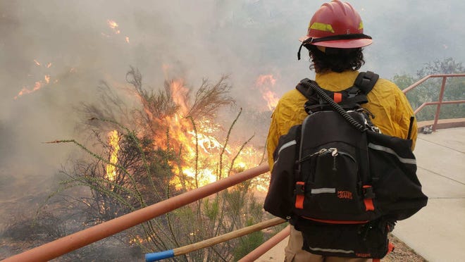 A firefighter stares at the Woodbury Fire in the Superstition Wilderness.