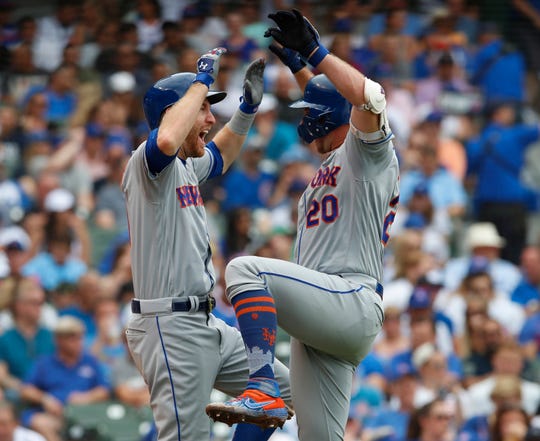Jun 23, 2019; Chicago, IL, USA; New York Mets first baseman Pete Alonso (20) celebrates his home run against the Chicago Cubs with New York Mets third baseman Todd Frazier (21) during the fourth Inning at Wrigley Field. Mandatory Credit: Jim Young-USA TODAY Sports