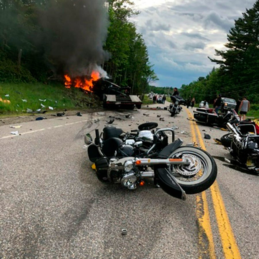 This photo provided by Miranda Thompson shows the scene where several motorcycles and a pickup truck collided on a rural, two-lane highway Friday, June 21, 2019 in Randolph, N.H.  New Hampshire State Police said a 2016 Dodge 2500 pickup truck collided with the riders on U.S. 2 Friday evening. The cause of the deadly collision is not yet known. The pickup truck was on fire when emergency crews arrived.