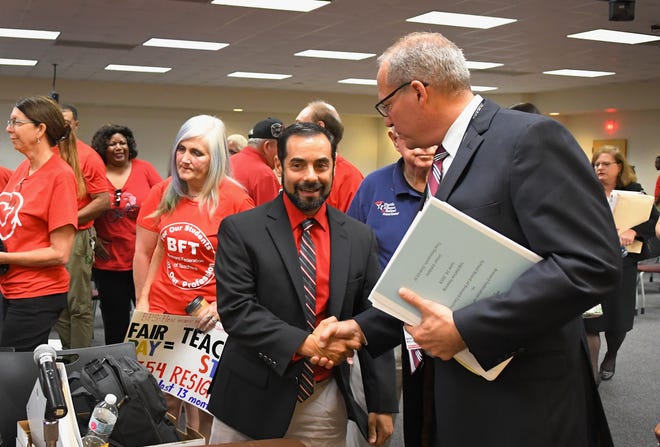  Anthony Colucci, president of the Brevard Federation of Teachers, and Mark Mullins, Brevard Schools superintendent, shake hands following the meeting. Colucci has vowed to fight on for a bigger raise. An estimated 900 teachers and their supporters rallied outside and eventually filled the school board meeting room in Viera on Monday. They were fighting for a better raise than was proposed by superintendent Mark Mullins. After hearing both sides of the issues, the school board members eventually voted 4-1 to back the Mullins plan over the teacher's union plan that an impartial magistrate endorsed.