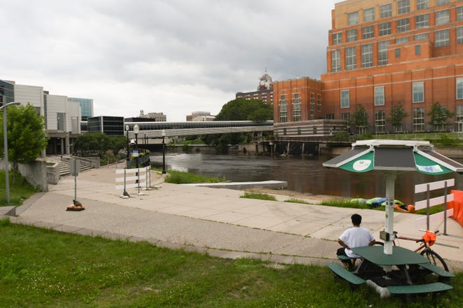 Santos Granado of Lansing took a break Monday from his ride along the River Trail in downtown Lansing. At that time, he wasn't aware of the Ingham County Health Department's no contact order for the river.