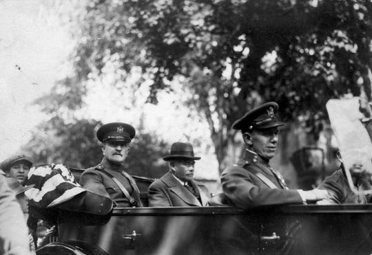 Gen. John J. Pershing and Passaic School Board President Robert Dix Benson, (backseat) and Lt. George Marshall (front seat), who eventually named Secretary of State, dedicate Passaic's cenotaph on Memorial Day 1924.