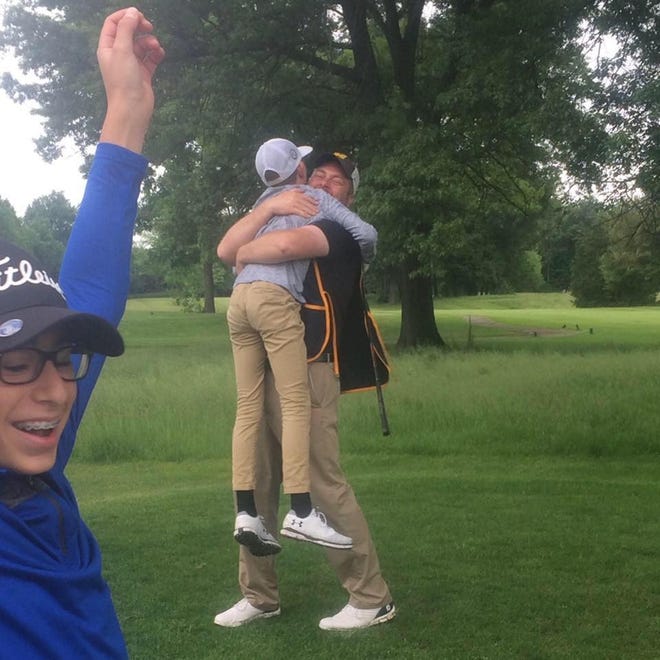 Braylon Park of Howell gets a hug from dad Matt after scoring a hole-in-one in his first tournament.