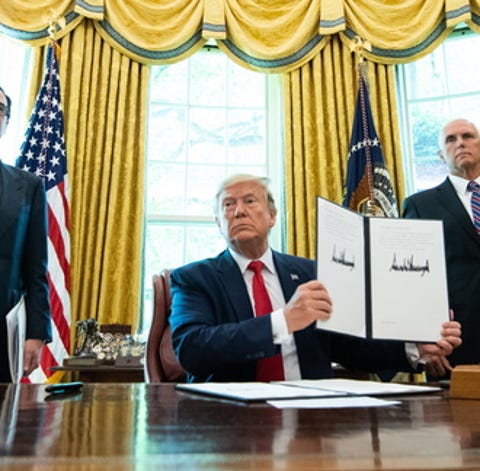 epa07670867 US President Donald J. Trump holds up...