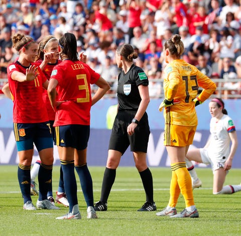 Spain players talk with the referee after the...